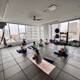 people in a spacious room doing yoga