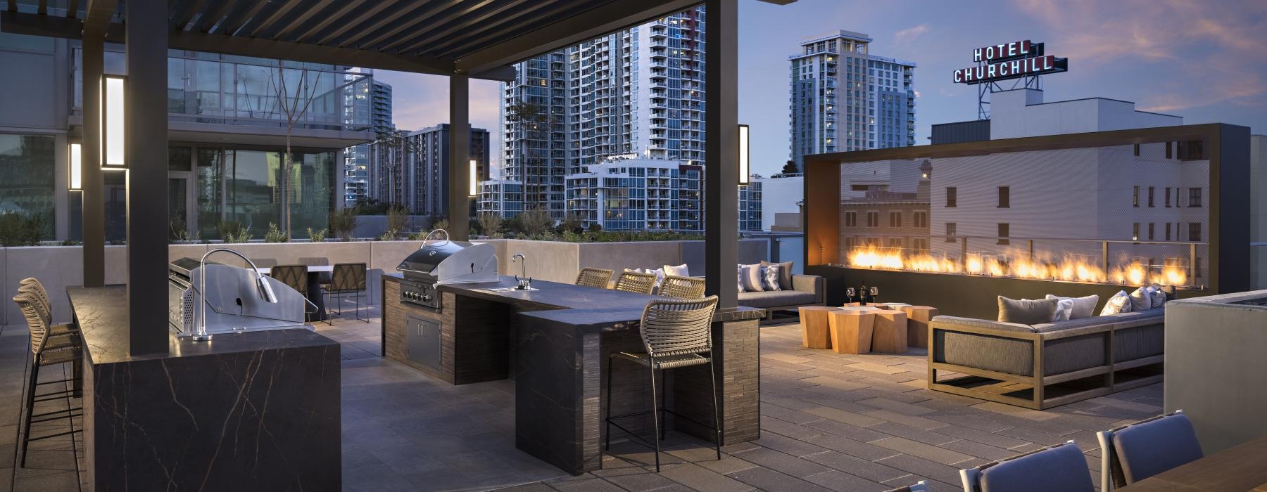 roofdeck grill area and seating beneath epic views of downtown area and of the city skyline